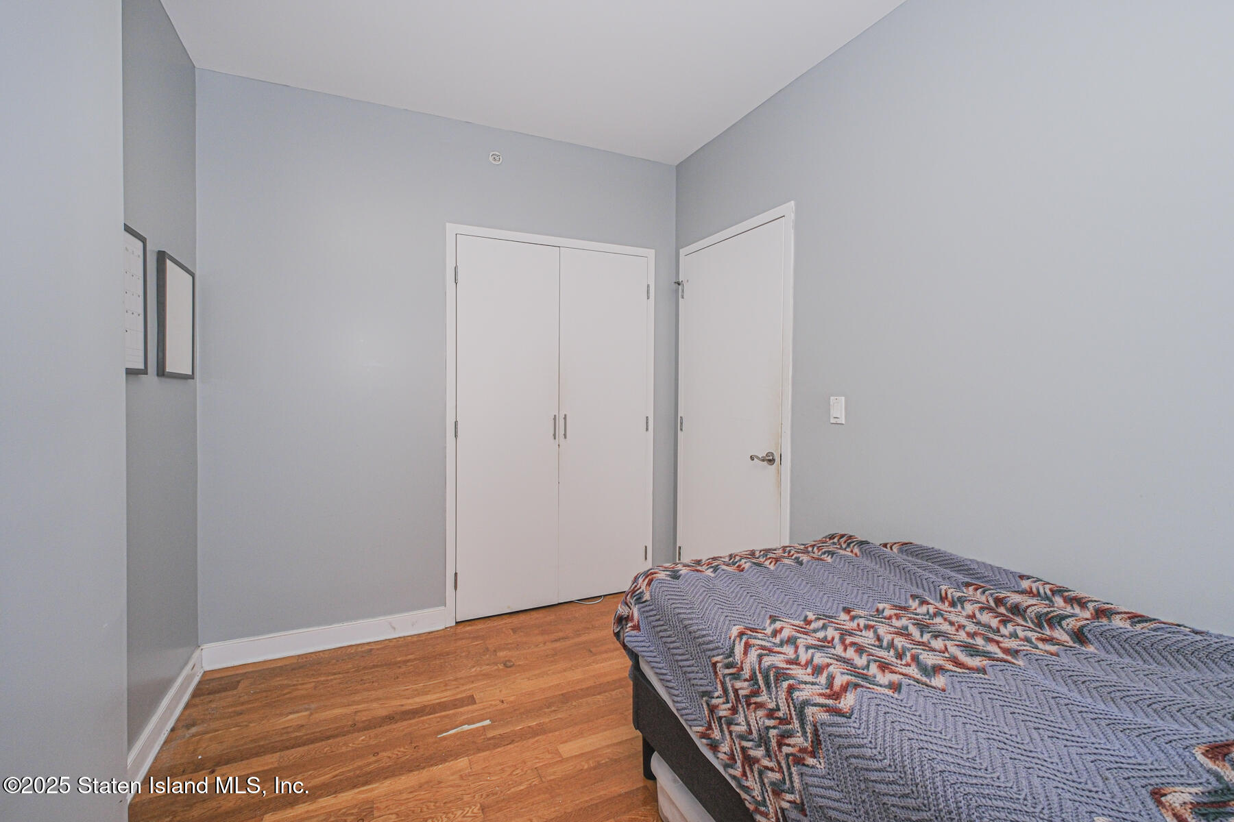 130 Beach 119th Street, Unit 3B Queens, NY 11694 - Photo 25 of 29 a bedroom with a bed and a window