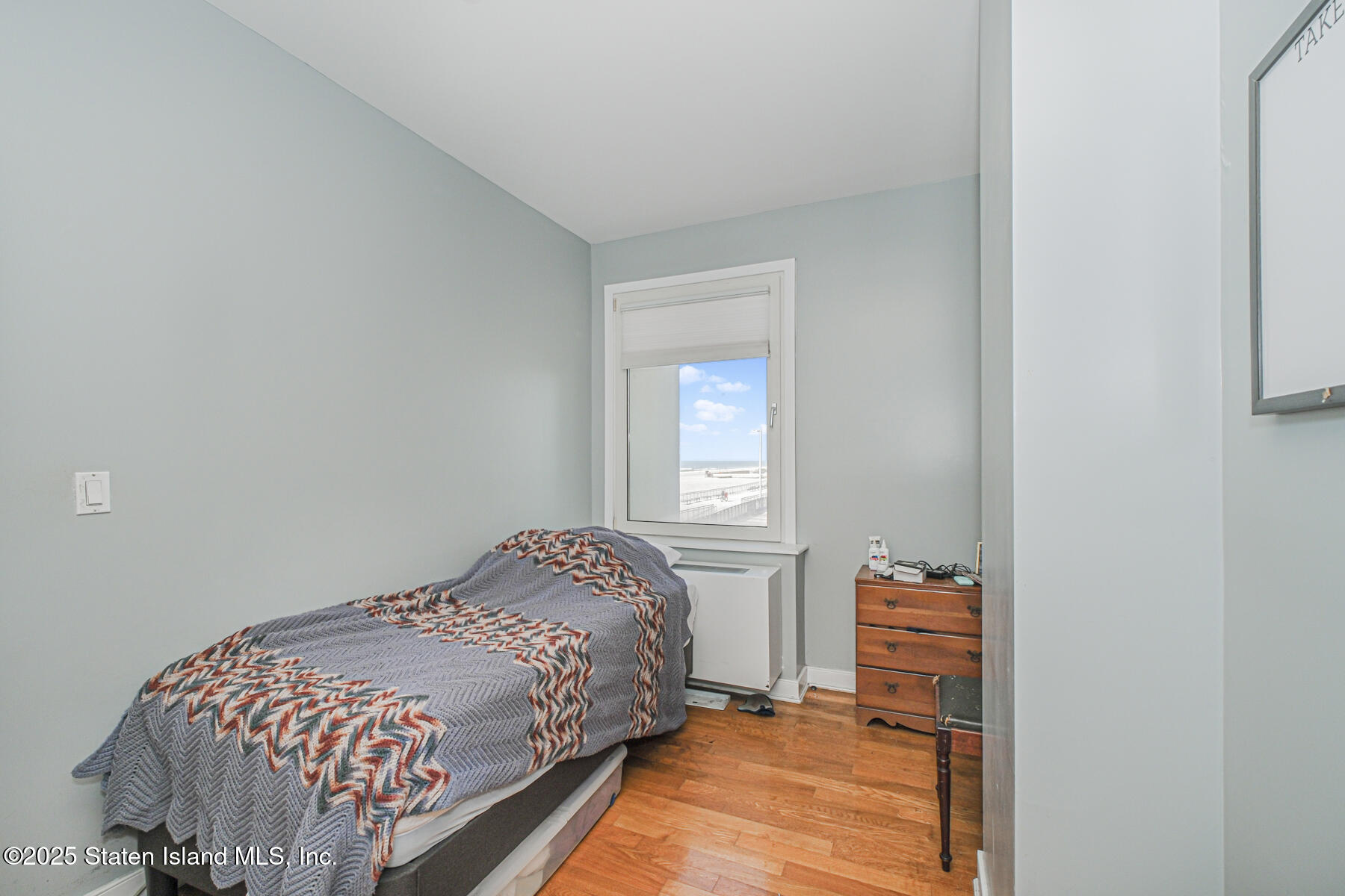 130 Beach 119th Street, Unit 3B Queens, NY 11694 - Photo 27 of 29 a bedroom with a bed and a window