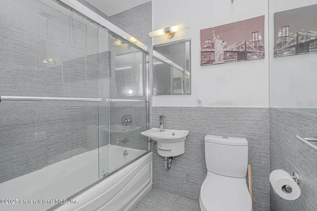 a bathroom with a toilet a sink and bathtub