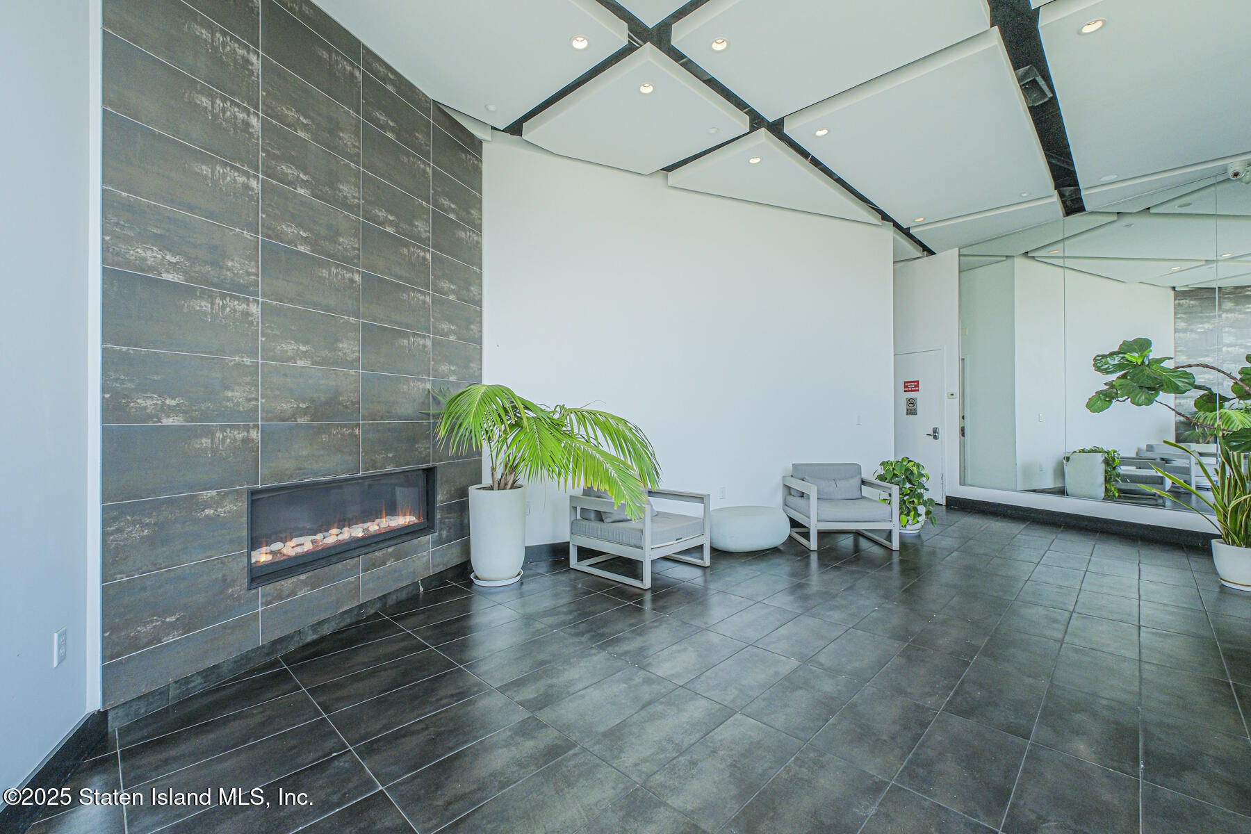 130 Beach 119th Street, Unit 3B Queens, NY 11694 - Photo 6 of 29 a living room with furniture and a fireplace