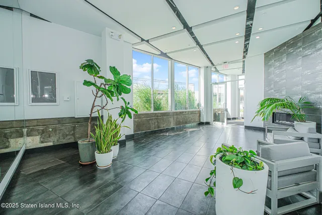a view of living room filled with furniture and a potted plant