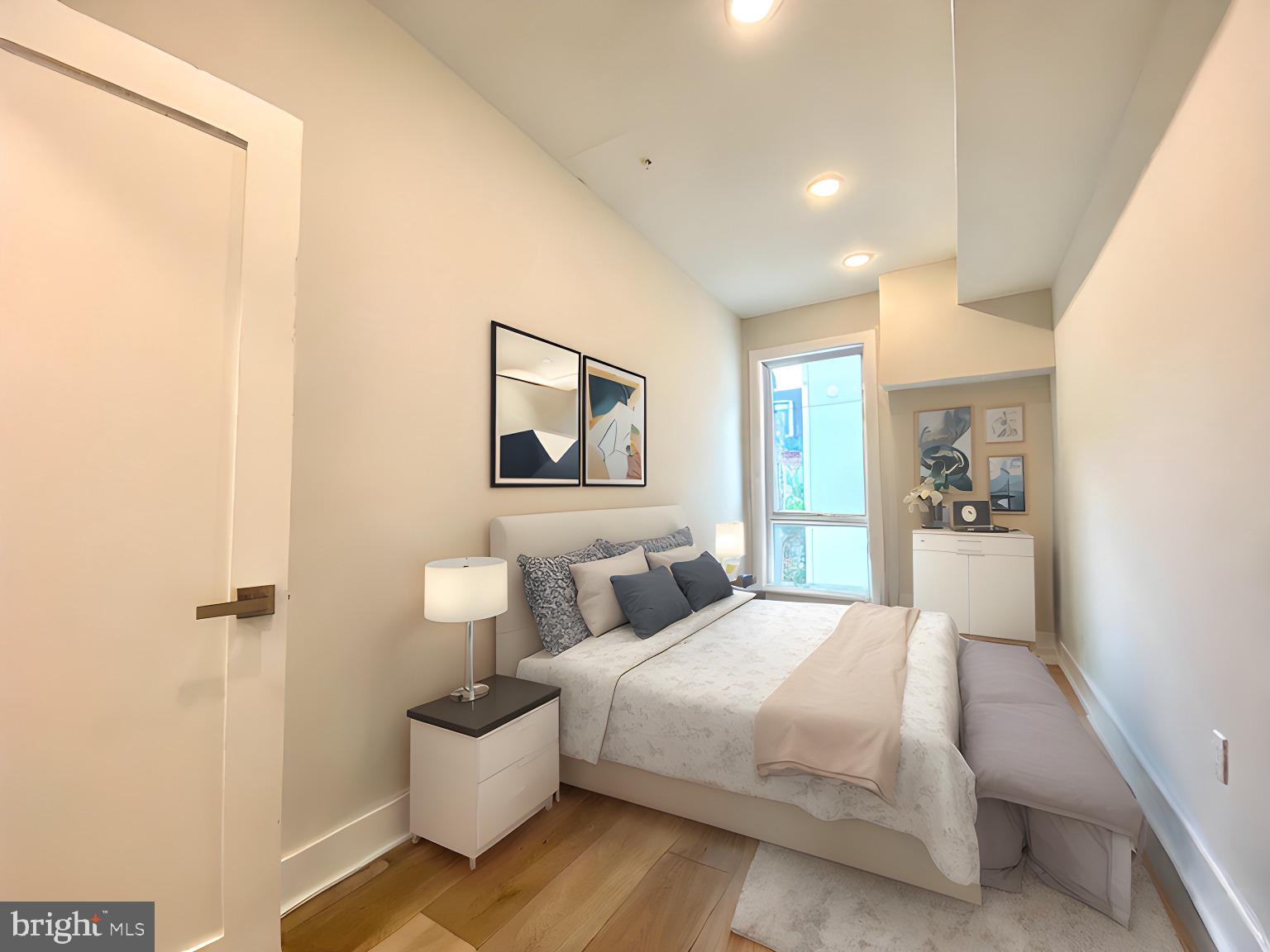 2216 Walnut Street, Unit 401 Philadelphia, PA 19103 - Photo 14 of 20 a bedroom with a bed and painting on the wall