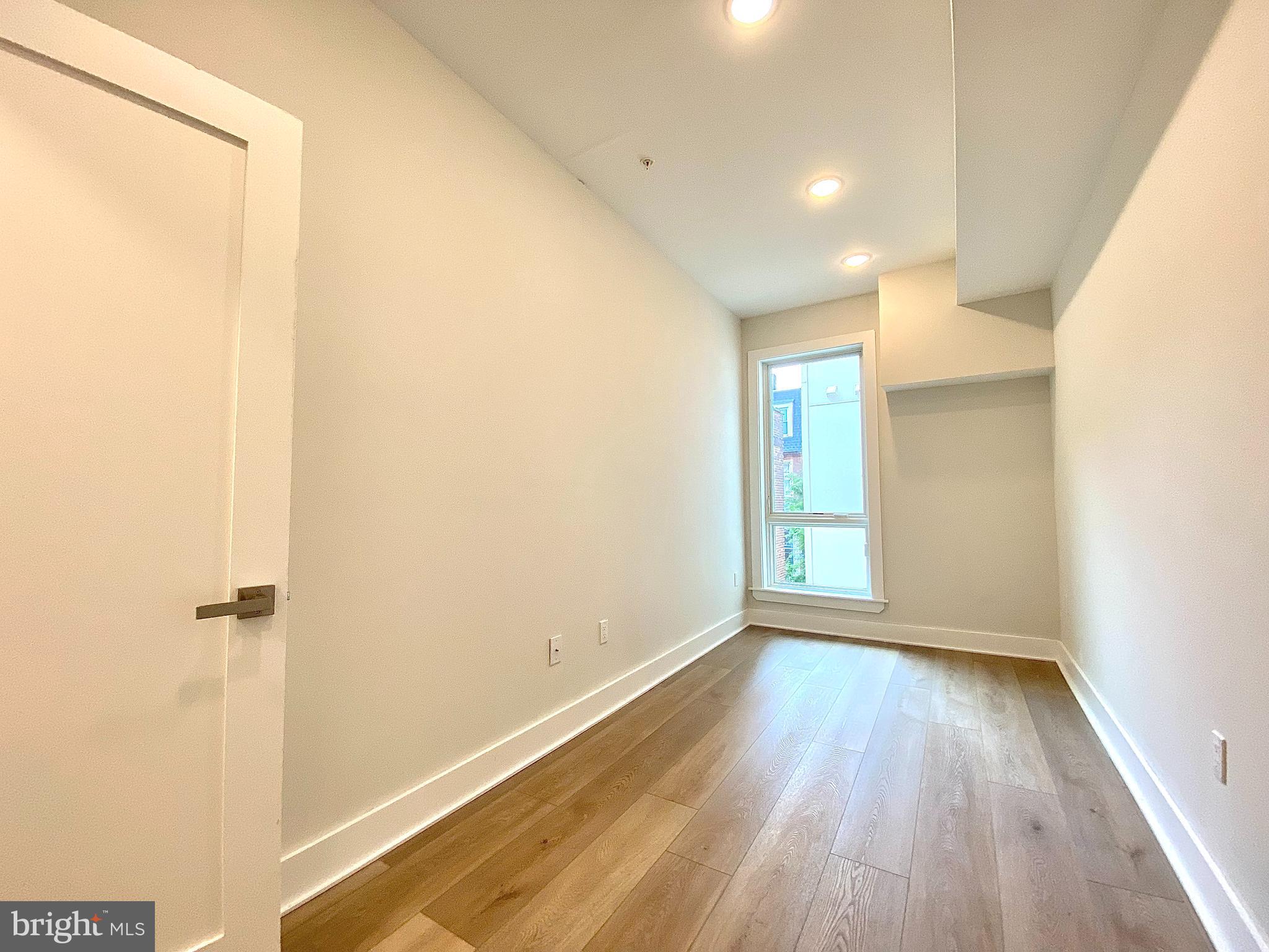 2216 Walnut Street, Unit 401 Philadelphia, PA 19103 - Photo 15 of 20 a view of a room with wooden floor and window