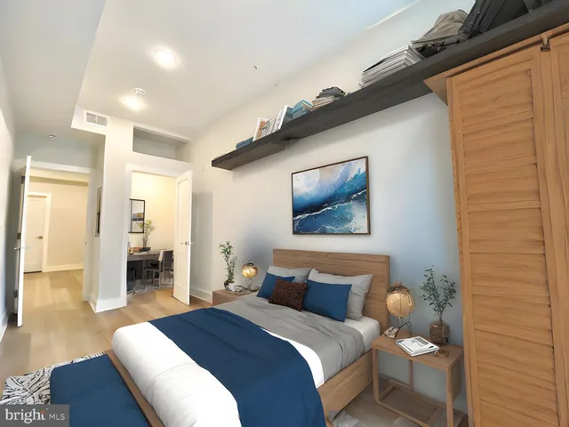 a bedroom with a bed and a painting on the wall