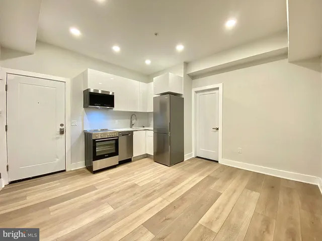 a kitchen with a refrigerator and a stove