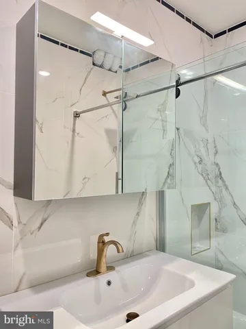 a bathroom with a sink and shower