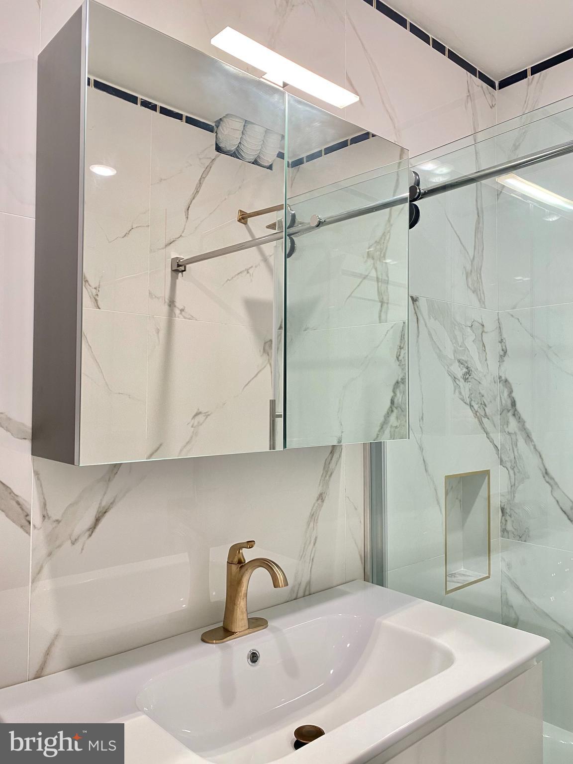 2216 Walnut Street, Unit 401 Philadelphia, PA 19103 - Photo 8 of 20 a bathroom with a sink and shower