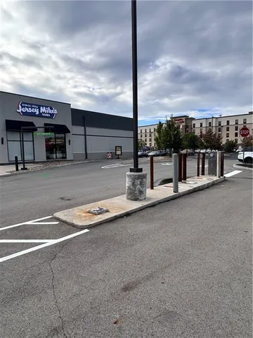 a view of a street with a table and chairs