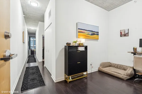 a view of a bedroom with furniture and wooden floor