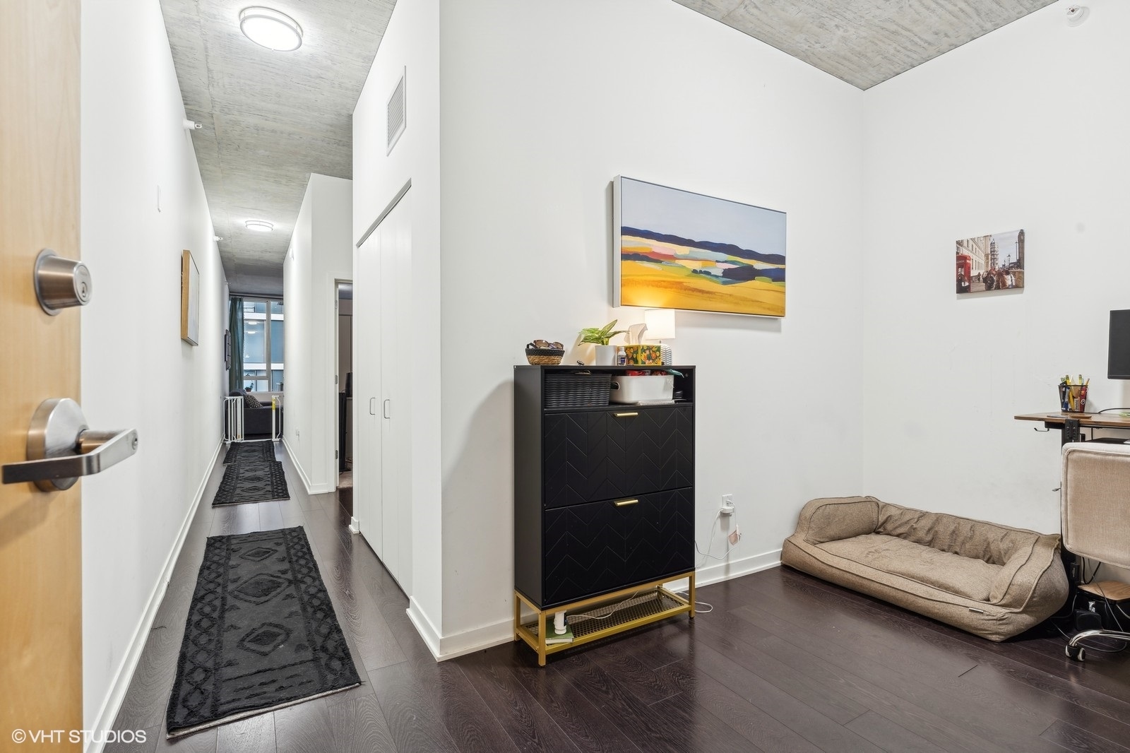 1345 South Wabash Avenue, Unit 1408 Chicago, IL 60605 - Photo 2 of 13 a view of a bedroom with furniture and wooden floor