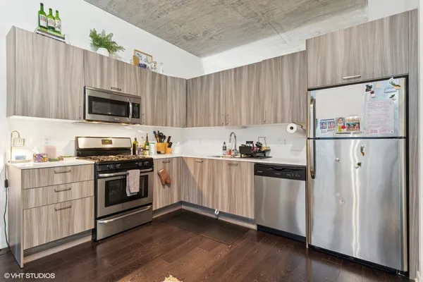 a kitchen with granite countertop white cabinets and white appliances