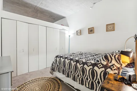 a bedroom with a bed and a painting on the wall