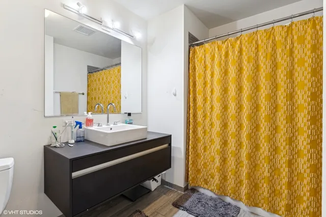 a view of bathroom with a sink and mirror
