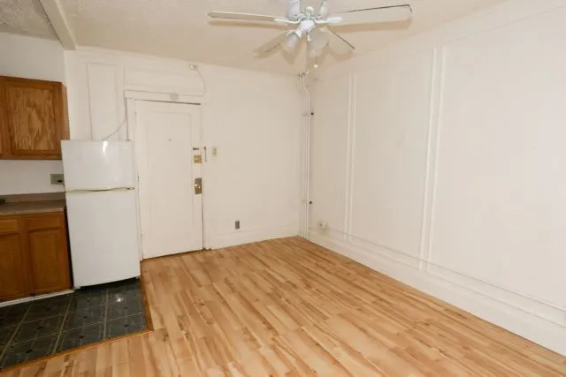 a view of a room with wooden floor