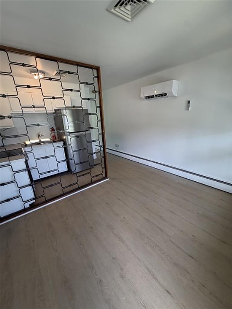 5391 Chapmans Road, Unit 1 Orefield, PA 18069 - Photo 5 of 7 Well-lit living space with durable flooring and modern air conditioning for comfort.