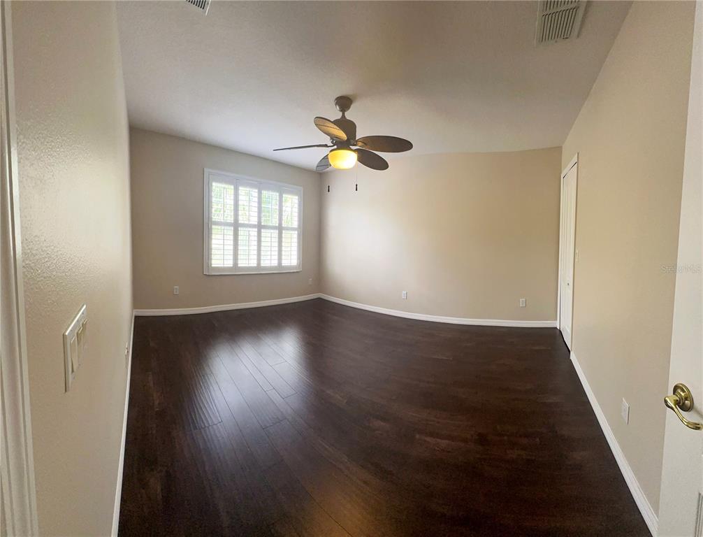557 Palio Court Ocoee, FL 34761 - Photo 14 of 18 an empty room with wooden floor and windows