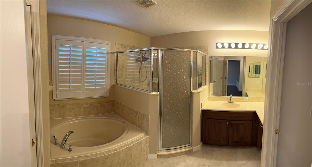 557 Palio Court Ocoee, FL 34761 - Photo 15 of 18 a bathroom with a shower and a sink