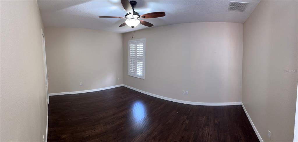 557 Palio Court Ocoee, FL 34761 - Photo 16 of 18 wooden floor in an empty room with a window
