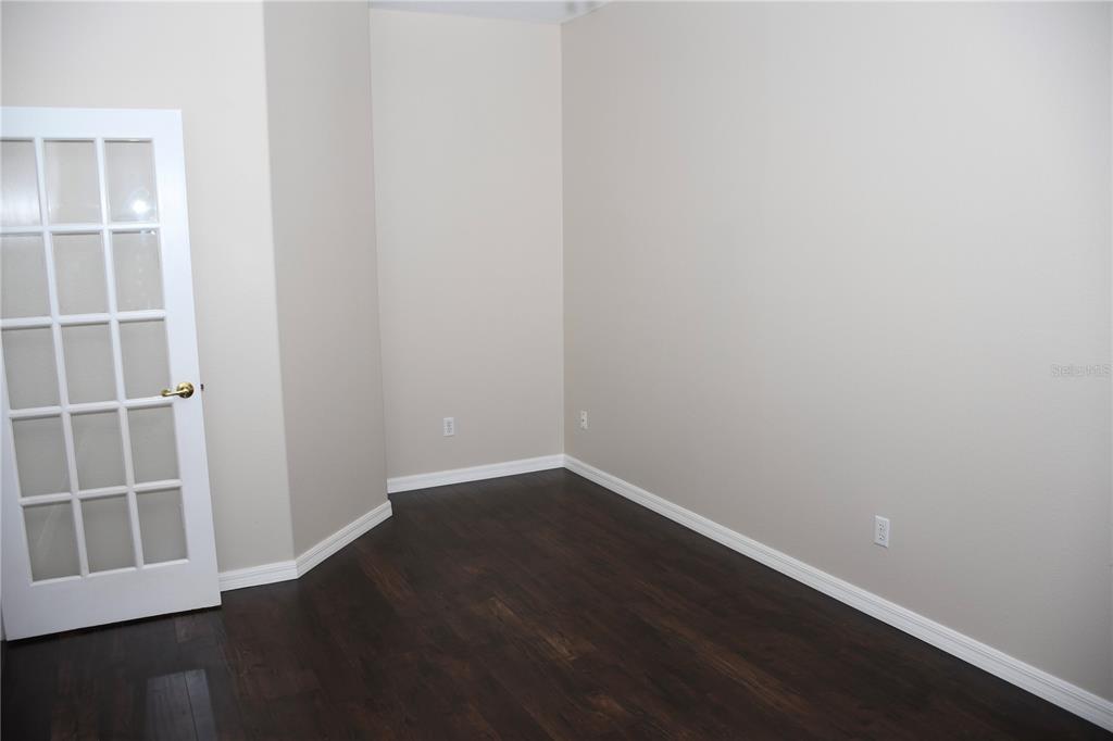 557 Palio Court Ocoee, FL 34761 - Photo 5 of 18 a view of an empty room with wooden floor and a window