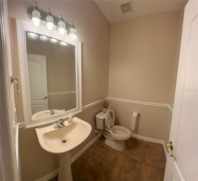 557 Palio Court Ocoee, FL 34761 - Photo 6 of 18 a bathroom with a sink a toilet and mirror
