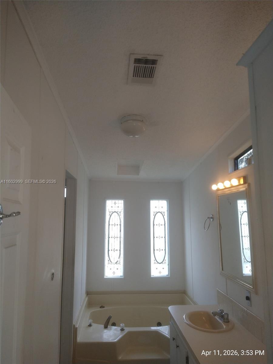 35250 Southwest 177th Court, Unit 136 Homestead, FL 33034 - Photo 14 of 23 a bathroom with a sink a toilet and shower