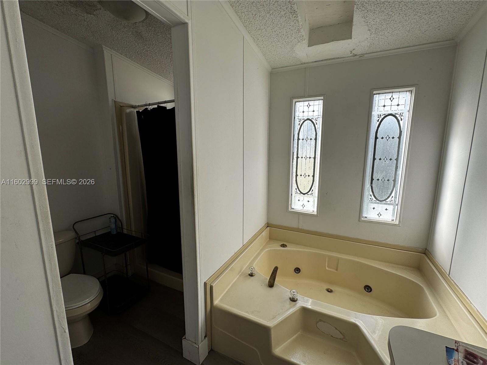 35250 Southwest 177th Court, Unit 136 Homestead, FL 33034 - Photo 15 of 23 a bathroom with a tub a sink and a toilet