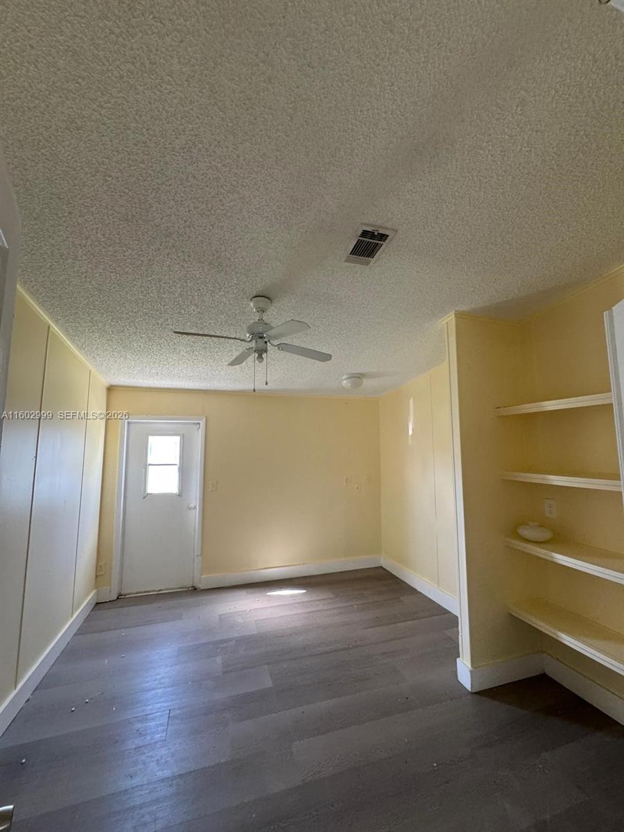 35250 Southwest 177th Court, Unit 136 Homestead, FL 33034 - Photo 18 of 23 an empty room with wooden floor and window