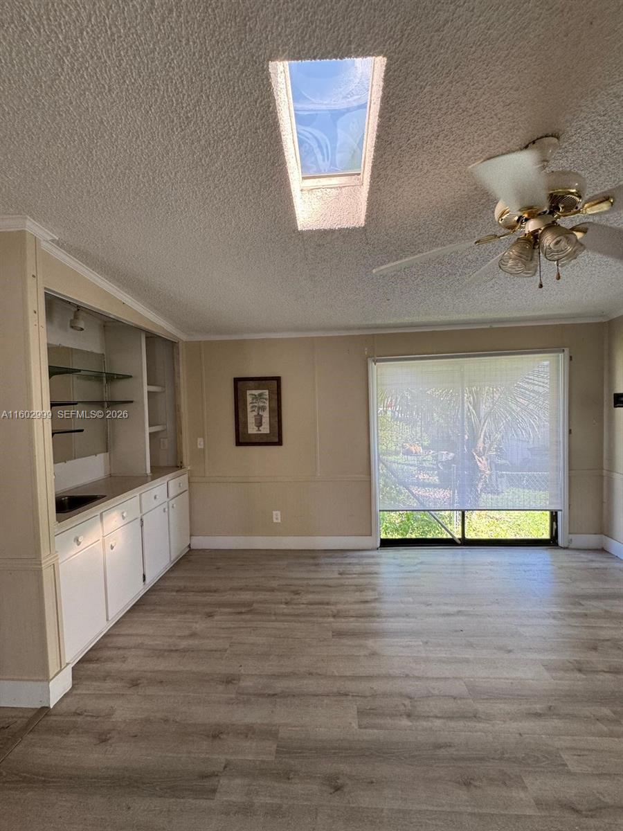 35250 Southwest 177th Court, Unit 136 Homestead, FL 33034 - Photo 20 of 23 a view of an empty room with a window and a kitchen