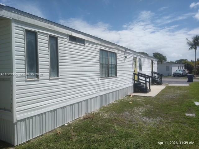 35250 Southwest 177th Court, Unit 136 Homestead, FL 33034 - Photo 22 of 23 a house view with a backyard space