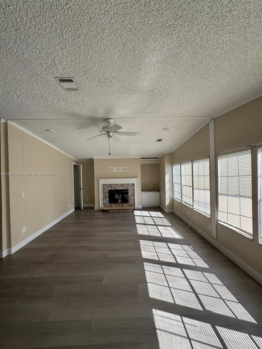 35250 Southwest 177th Court, Unit 136 Homestead, FL 33034 - Photo 4 of 23 a view of an empty room with a fireplace and a window
