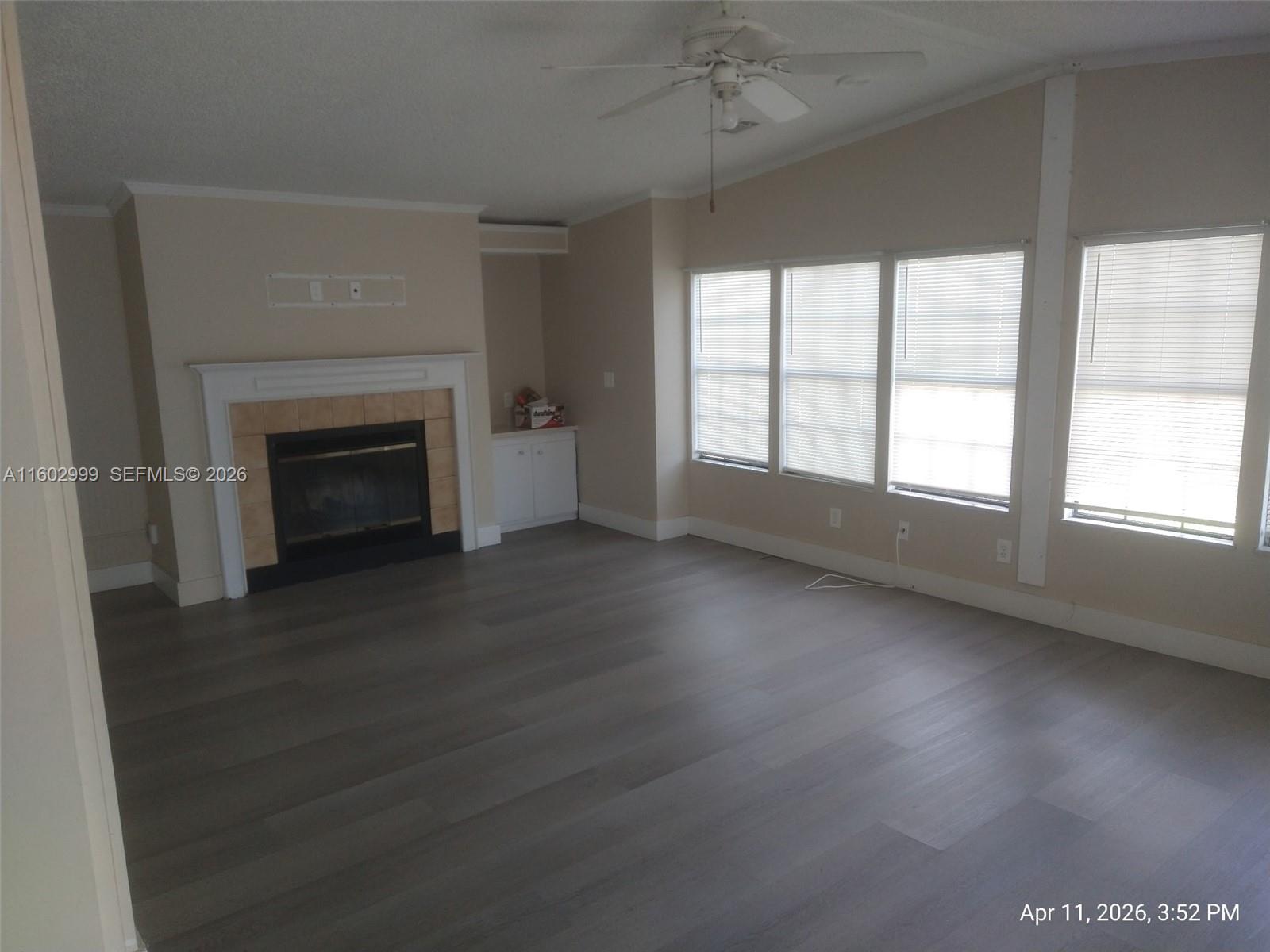35250 Southwest 177th Court, Unit 136 Homestead, FL 33034 - Photo 5 of 23 an empty room with windows and fireplace