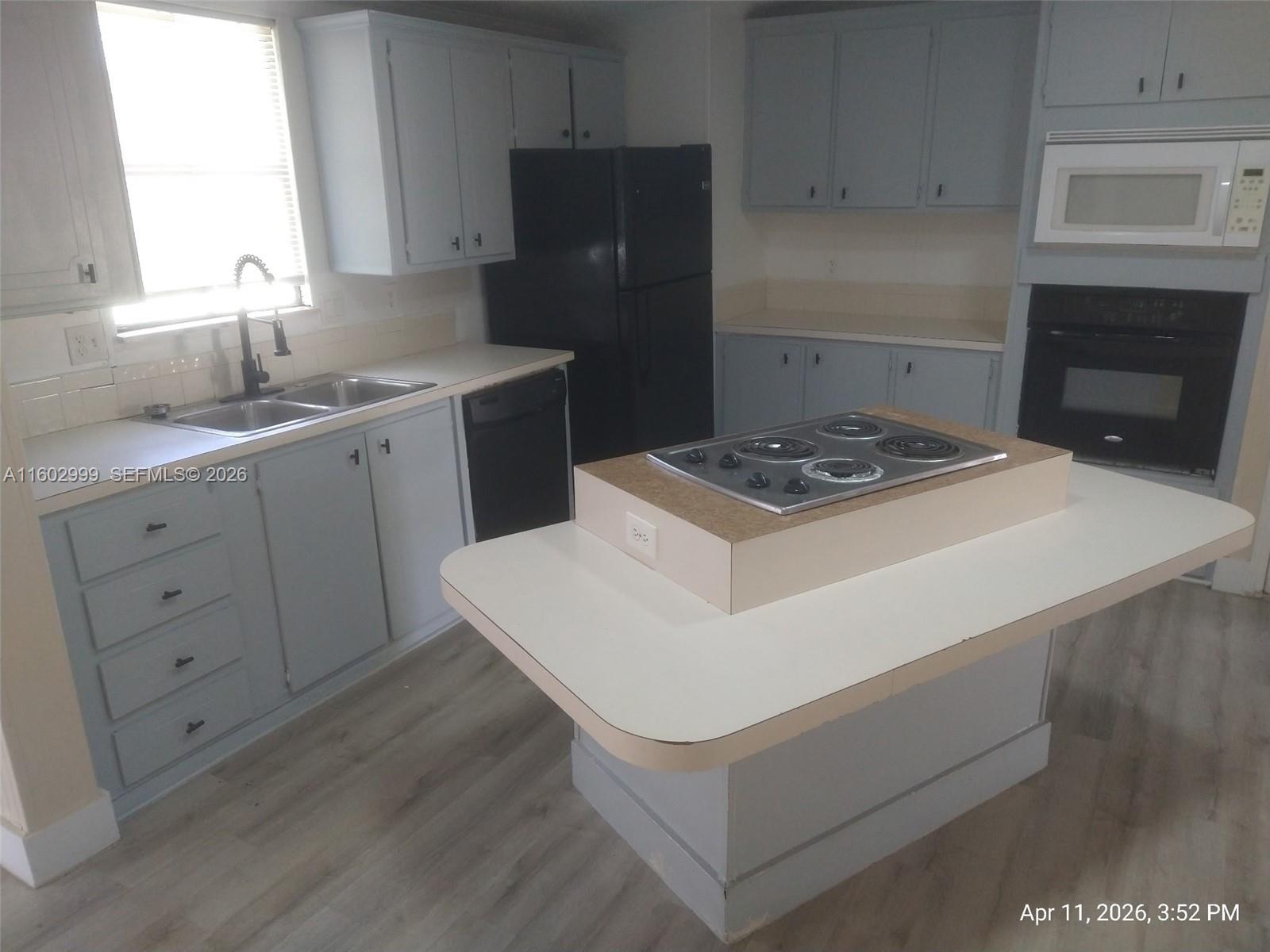35250 Southwest 177th Court, Unit 136 Homestead, FL 33034 - Photo 7 of 23 a kitchen with a stove and a refrigerator