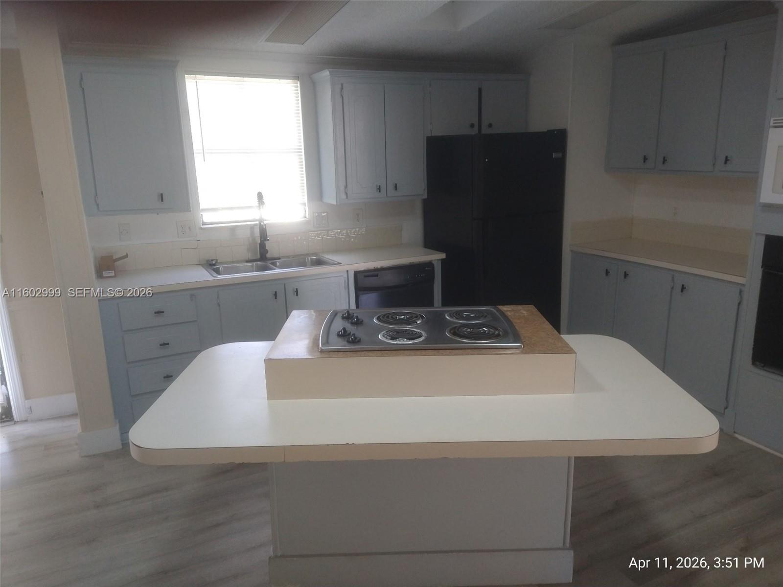 35250 Southwest 177th Court, Unit 136 Homestead, FL 33034 - Photo 8 of 23 a kitchen with a stove and a refrigerator