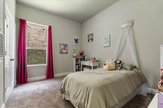 a bedroom with furniture and a window