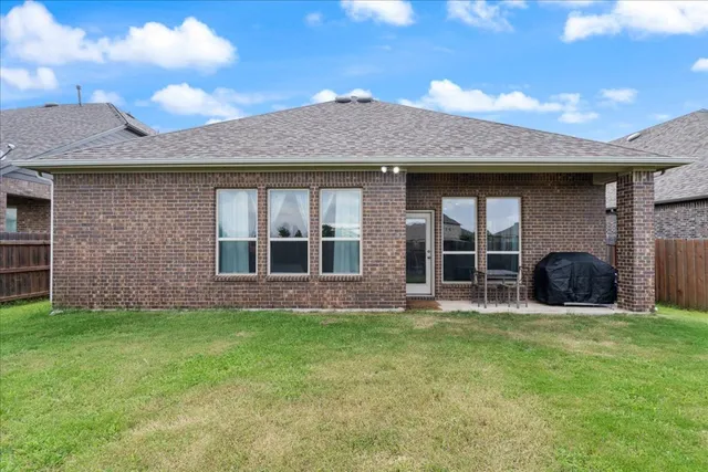 a front view of house with yard barbeque oven and seating