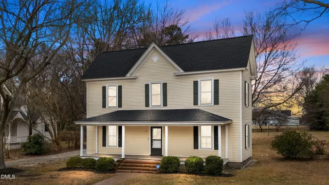 a front view of a house with yard and garage