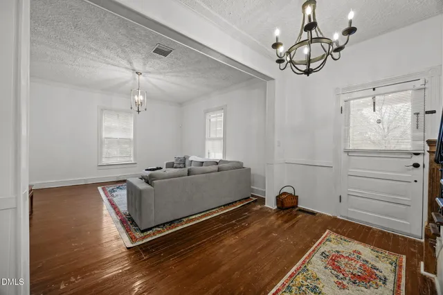 a living room with a bed furniture and a window