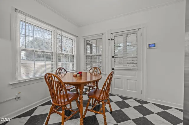 a dining room with furniture and window