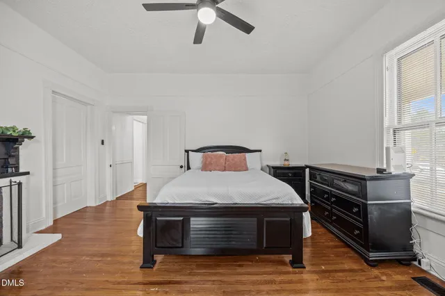 a bedroom with a bed and wooden floor