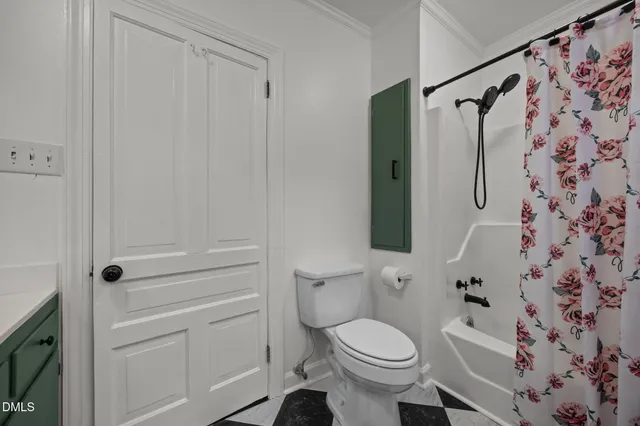 a bathroom with a toilet and shower