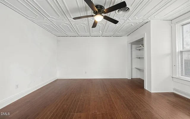 a view of a room with wooden floor