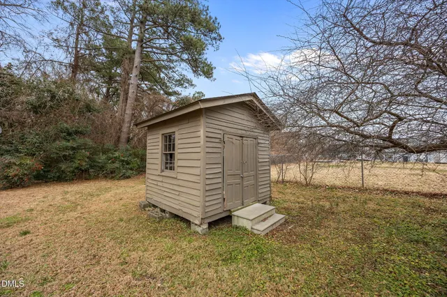 a view of a wooden house with a yard