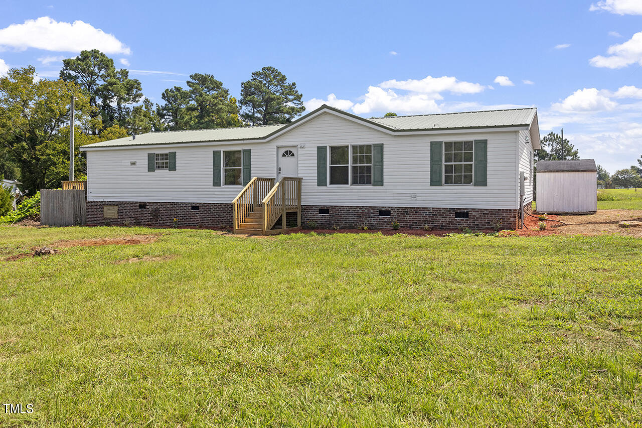 10335 West Old Spring Hope Road Spring Hope, NC 27882 - Photo 1 of 20 a front view of a house with a yard and garage