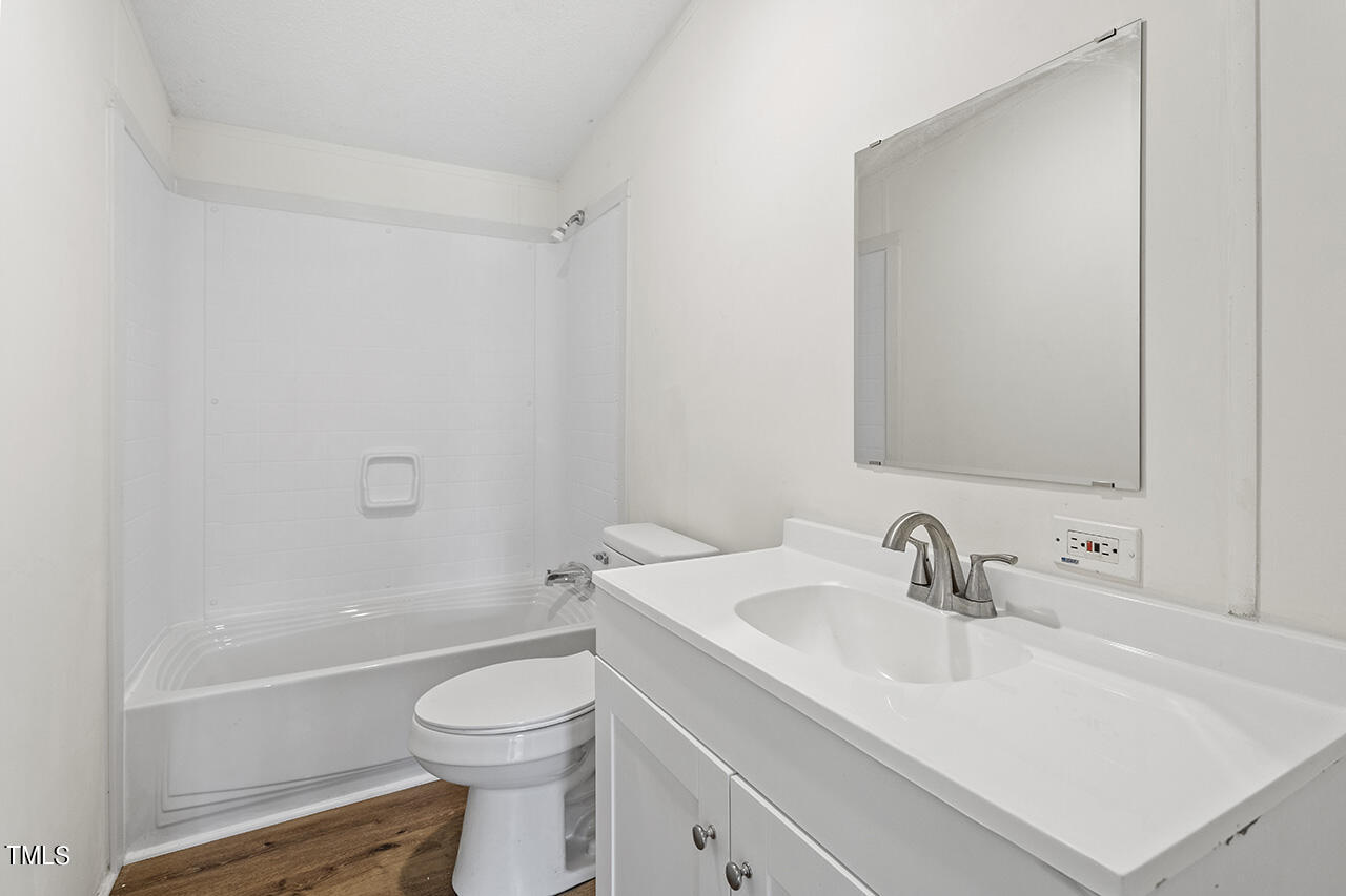 10335 West Old Spring Hope Road Spring Hope, NC 27882 - Photo 12 of 20 a bathroom with a sink a toilet and shower