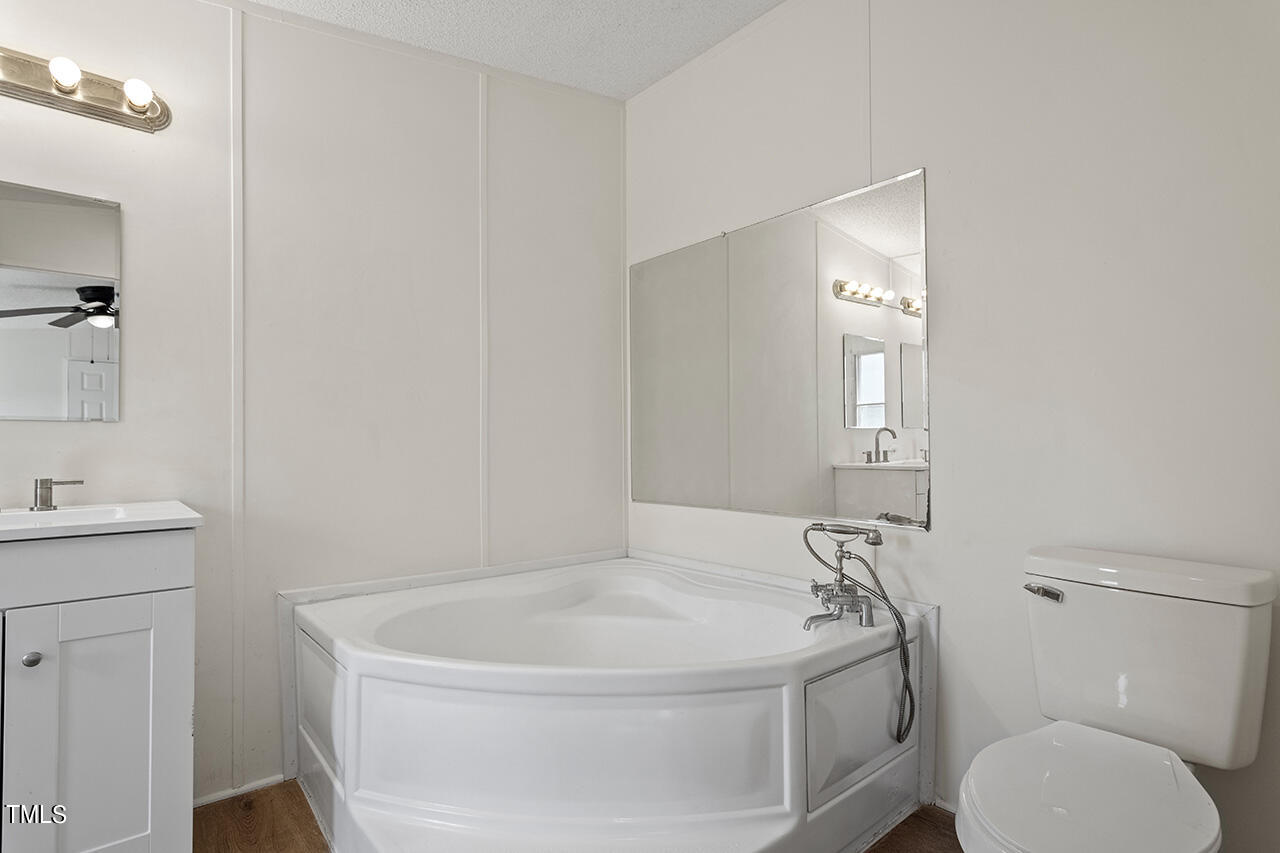 10335 West Old Spring Hope Road Spring Hope, NC 27882 - Photo 14 of 20 a white bath tub sitting next to a white toilet