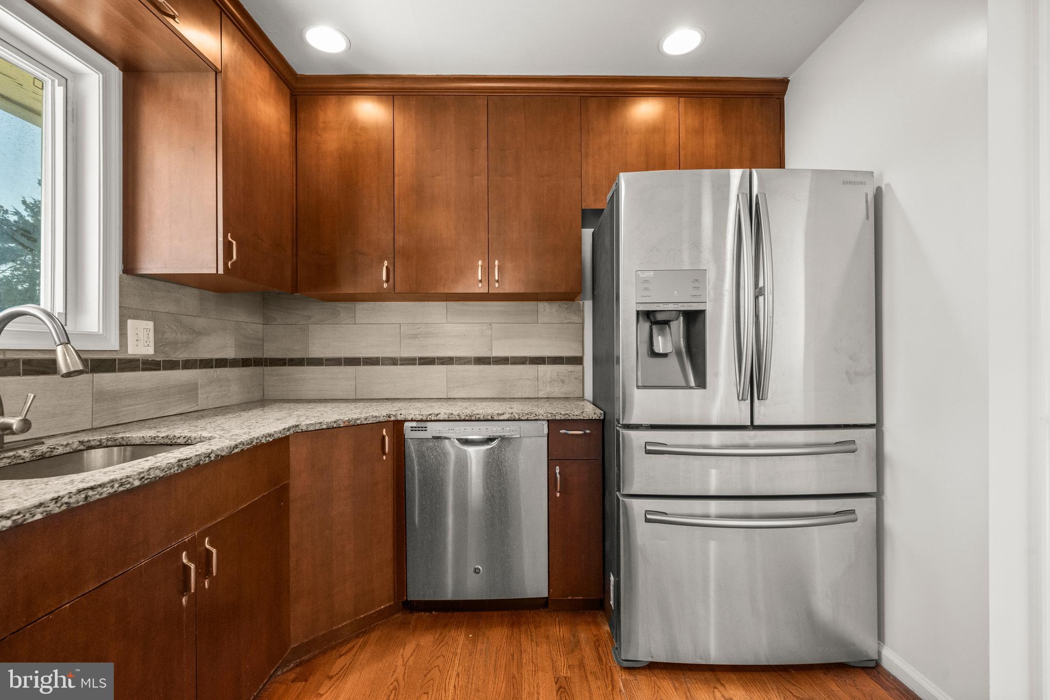 8100 Oxon Hill Road Fort Washington, MD 20744 - Photo 13 of 40 a kitchen with stainless steel appliances granite countertop a refrigerator sink and cabinets