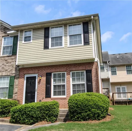 a view of a brick house with a yard
