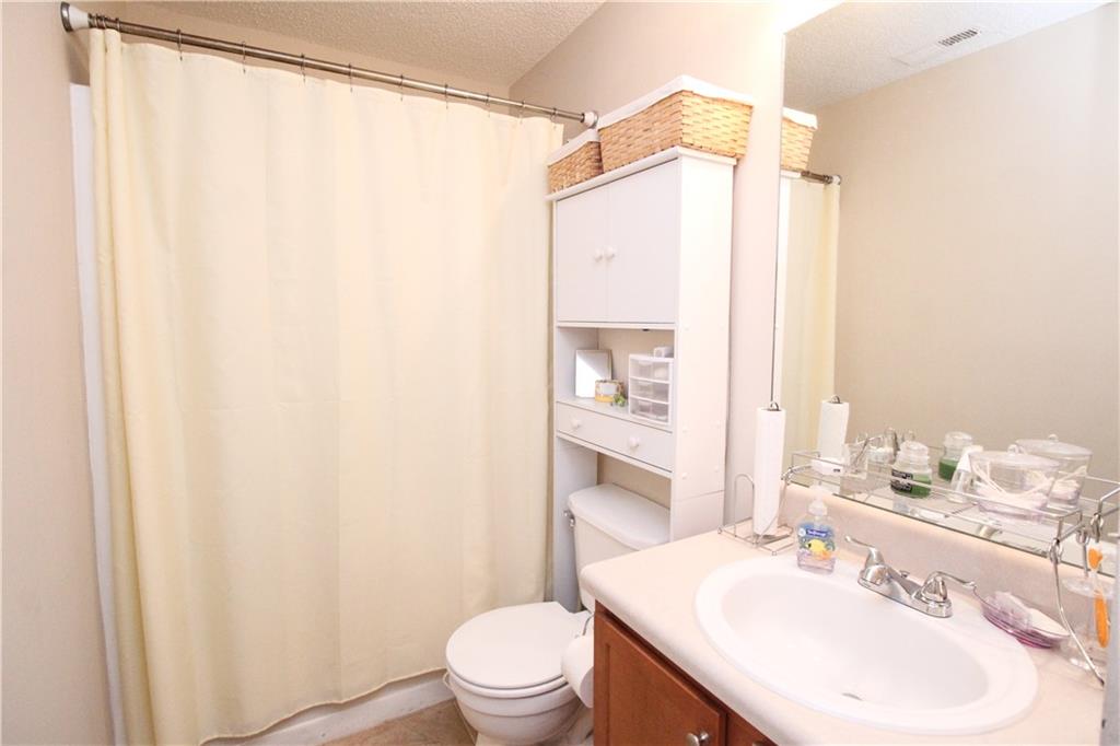 3620 Ginnis Road, Unit 4 Atlanta, GA 30331 - Photo 10 of 17 a bathroom with a sink mirror vanity and toilet