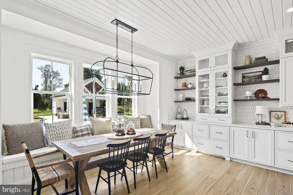 a view of a dining room with furniture window and wooden floor