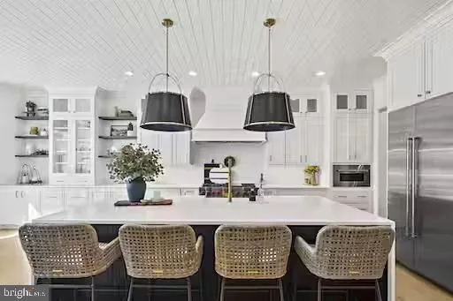 a kitchen with a table chairs and a chandelier